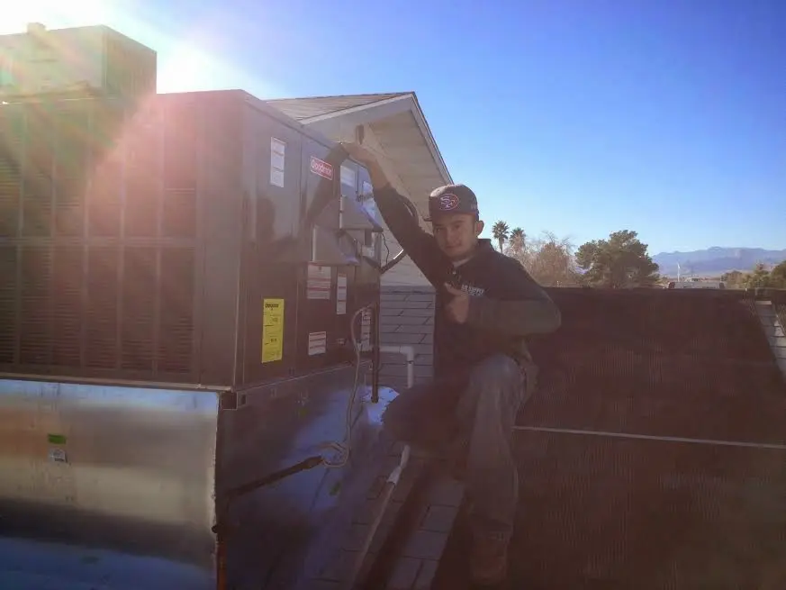 HVAC technician performing HVAC Inspection on a rooftop unit in Bucyrus