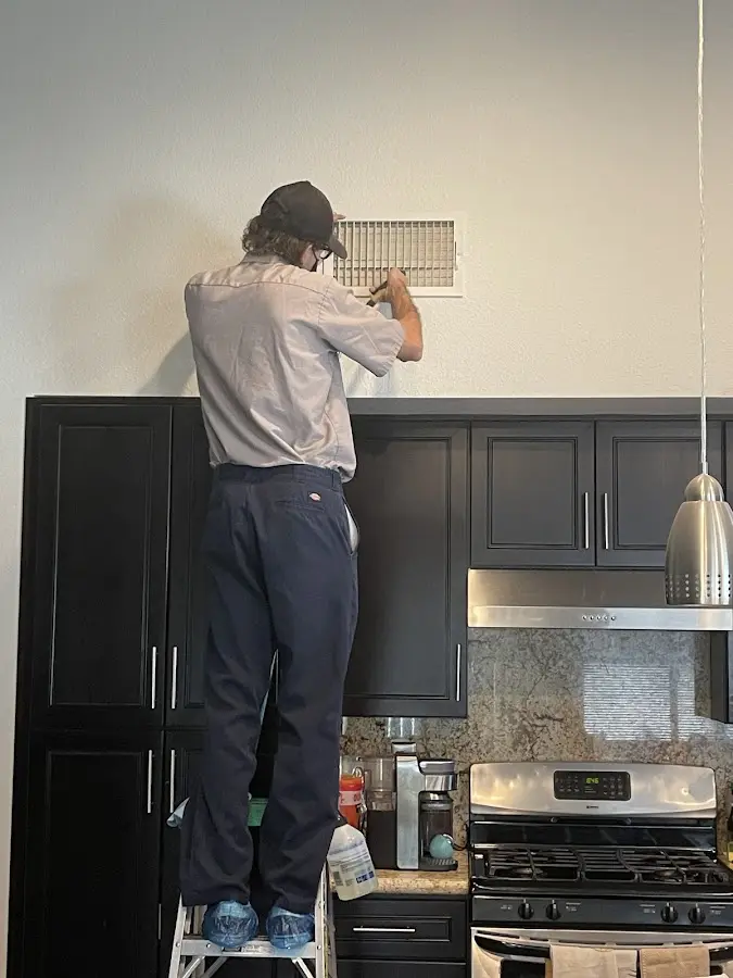 Technician inspecting an air vent during HVAC service in Bucyrus